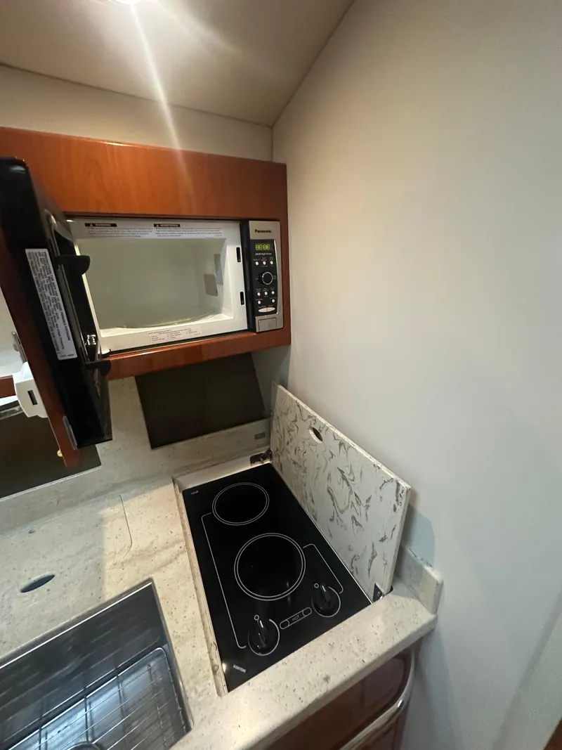 Slide: The Image of Compact kitchen in 2013 Formula 37 PC yacht with microwave and stovetop. - 9