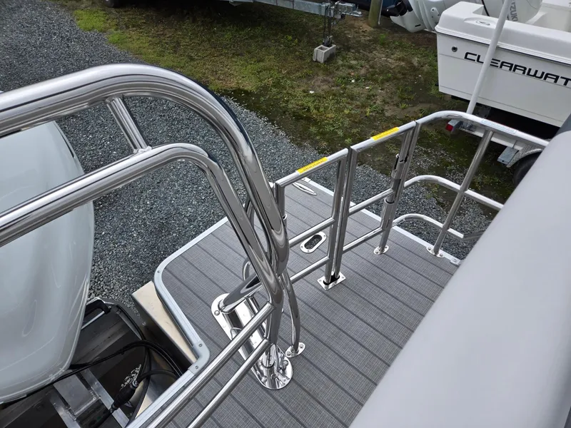 Slide: The Image of 2026 Godfrey SWEETWATER Entertainment 2486 DT boat deck with stainless steel railings. - 24