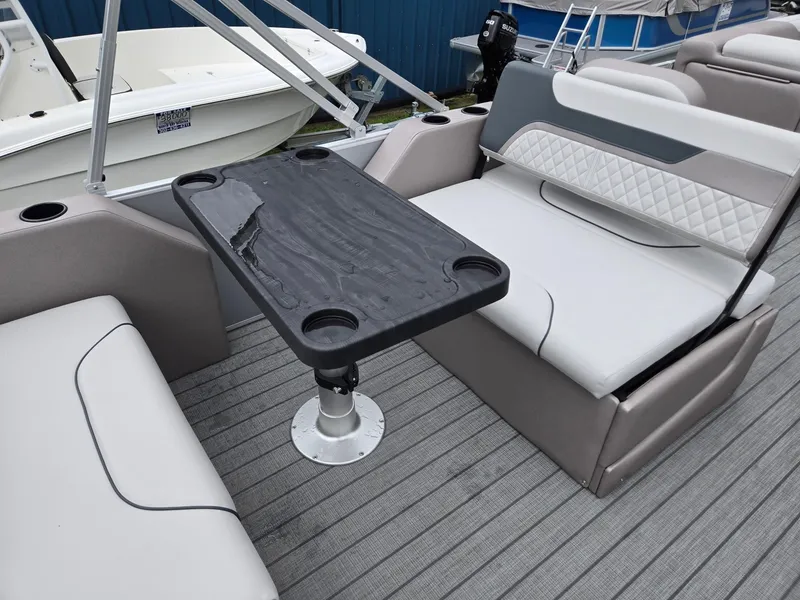 Slide: The Image of 2026 Godfrey SWEETWATER Entertainment 2486 DT boat interior with seating and table. - 27