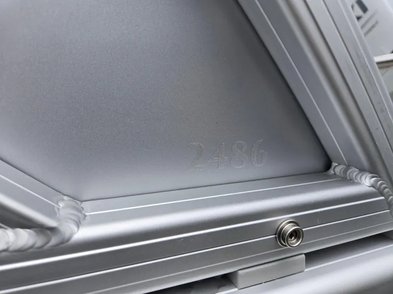 Slide: The Image of Close-up of Godfrey SWEETWATER Entertainment 2486 DT boat detail, showcasing sleek metallic finish. - 37