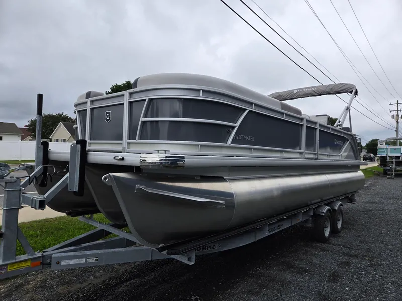 Slide: The Image of 2026 Godfrey SWEETWATER Entertainment 2486 DT pontoon boat on trailer, overcast day. - 6