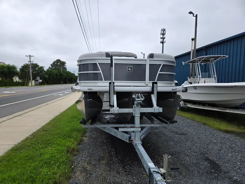 Slide: The Image of 2026 Godfrey SWEETWATER Entertainment 2486 DT pontoon boat on trailer, roadside view. - 7