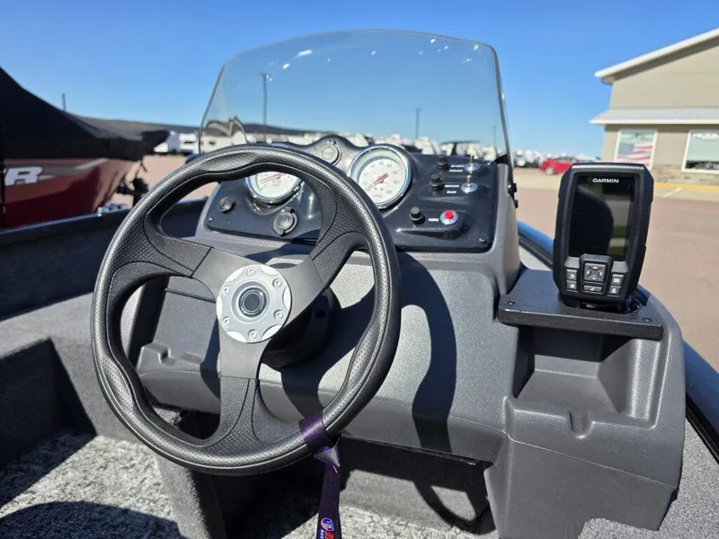Slide: The Image of 2025 Tracker Super Guide V-16 SC boat dashboard with steering wheel and Garmin device. - 10