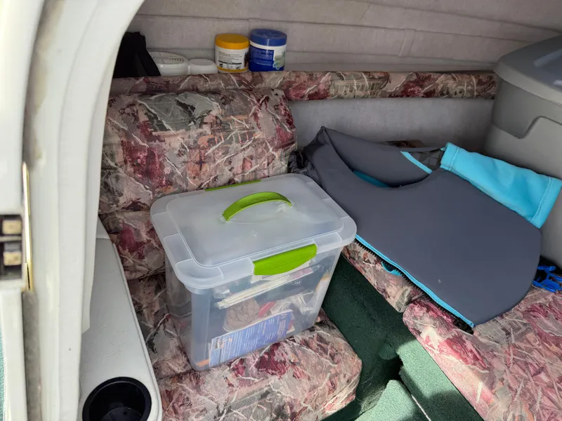 Slide: The Image of Interior of a 1996 Doral 216 Cuddy boat with storage and supplies. - 10