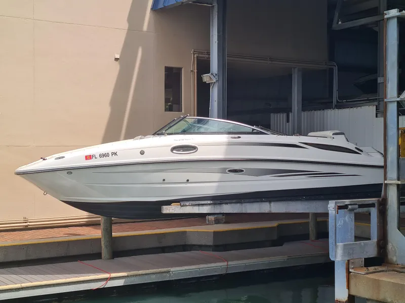Slide: The Image of 2012 Sea Ray 260 Sundeck boat docked in a marina. - 1
