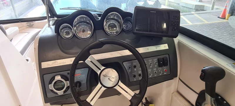 Slide: The Image of 2012 Sea Ray 260 Sundeck dashboard with steering wheel, gauges, and Garmin navigation system. - 10