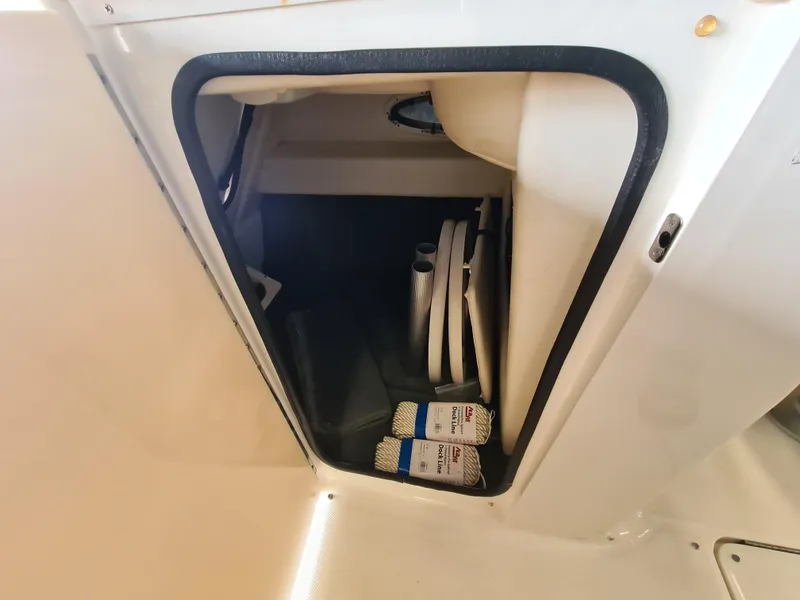 Slide: The Image of Storage compartment in 2012 Sea Ray 260 Sundeck boat with dock lines and accessories. - 12