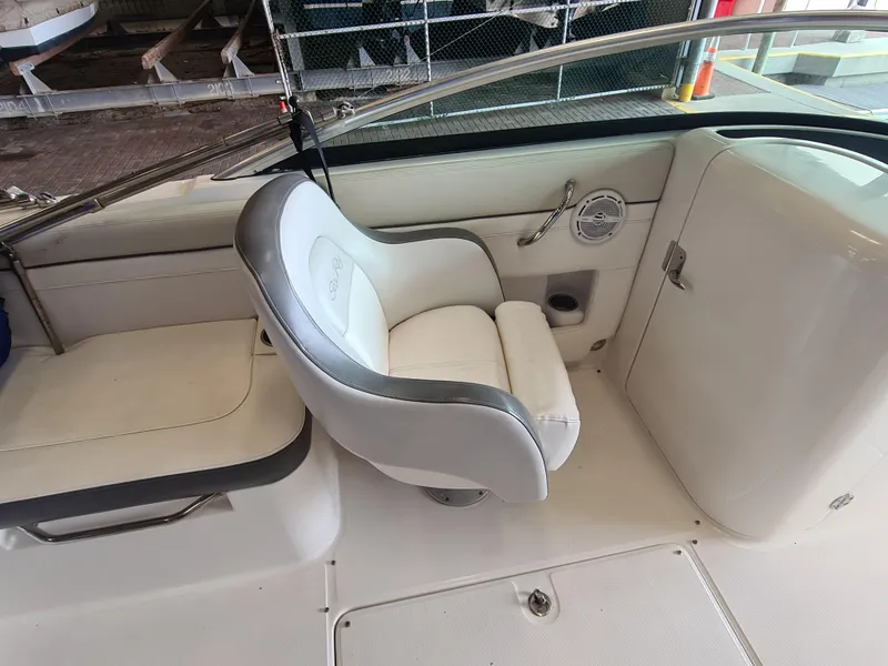 Slide: The Image of 2012 Sea Ray 260 Sundeck interior with white seating and sleek design. - 13