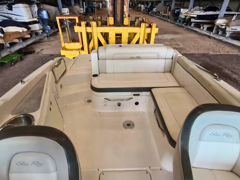 Slide: The Image of 2012 Sea Ray 260 Sundeck interior with white seating in storage facility. - 17