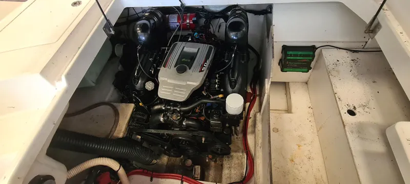 Slide: The Image of Engine compartment of a 2012 Sea Ray 260 Sundeck, showcasing the boat's motor and components. - 22