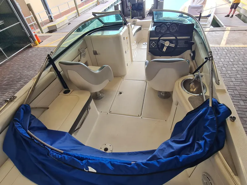 Slide: The Image of 2012 Sea Ray 260 Sundeck interior with seating, steering wheel, and blue cover. - 7