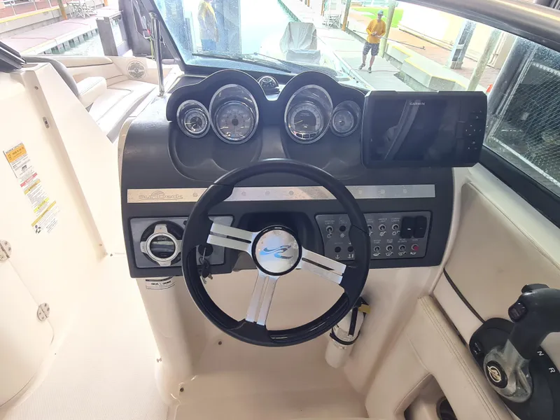 Slide: The Image of Steering console of a 2012 Sea Ray 260 Sundeck boat with gauges and controls. - 9
