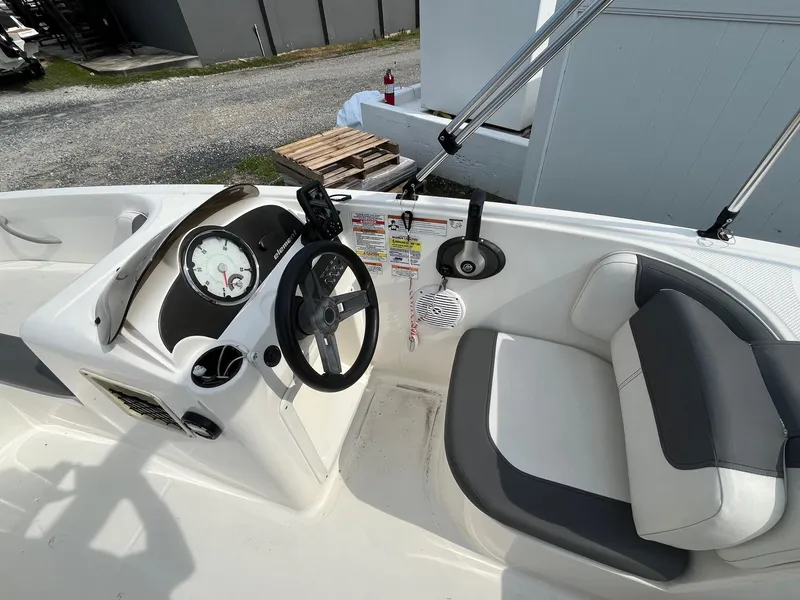 Slide: The Image of 2021 Bayliner Element E16 boat cockpit with steering wheel and seating. - 10