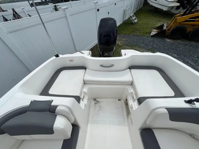 Slide: The Image of 2021 Bayliner Element E16 boat interior with white and gray seating. - 3