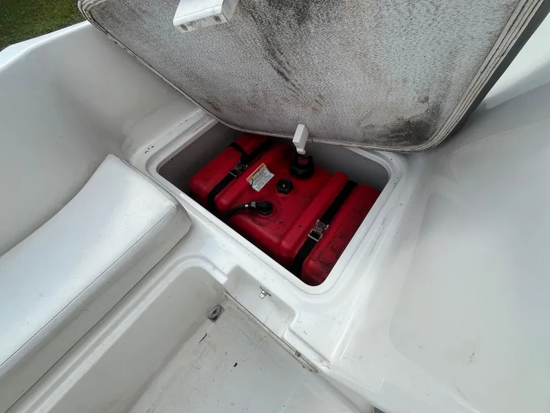 Slide: The Image of Open storage compartment with red fuel tank in 2021 Bayliner Element E16 boat. - 4