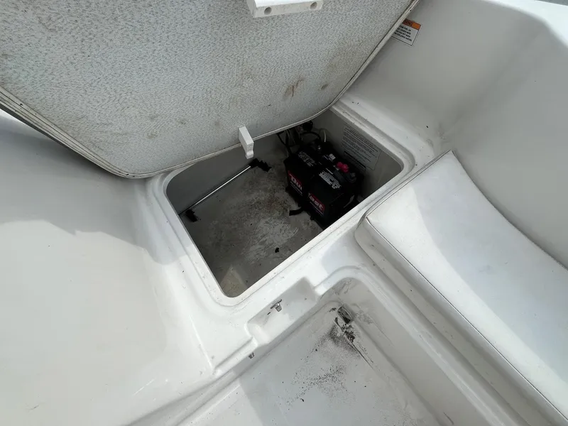 Slide: The Image of Open storage compartment on 2021 Bayliner Element E16 boat, revealing battery inside. - 5