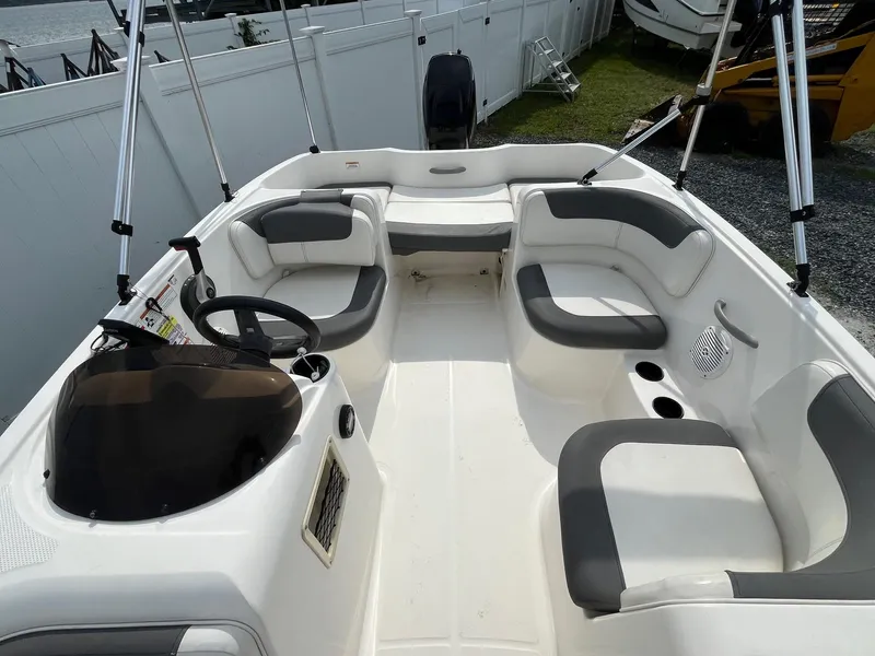 Slide: The Image of 2021 Bayliner Element E16 boat interior with seating and steering console. - 6