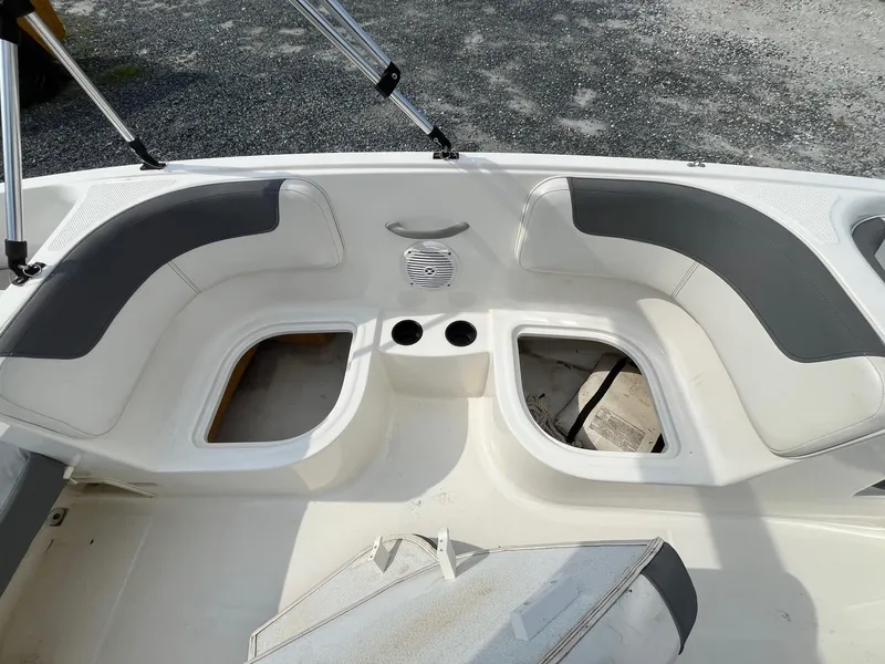 Slide: The Image of 2021 Bayliner Element E16 boat interior with seating and storage compartments. - 7