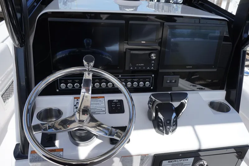 Slide: The Image of 2025 Sea Fox 282 Hybrid LT boat dashboard with steering wheel and electronic controls. - 12
