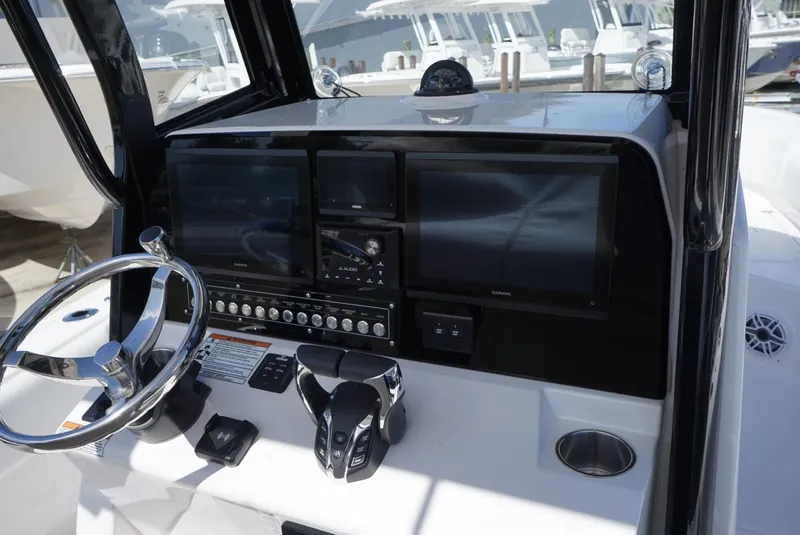Slide: The Image of 2025 Sea Fox 282 Hybrid LT boat dashboard with steering wheel and electronic displays. - 13