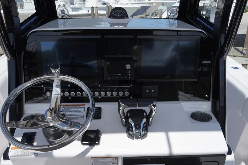 Slide: The Image of 2025 Sea Fox 282 Hybrid LT dashboard with steering wheel and advanced navigation displays. - 14