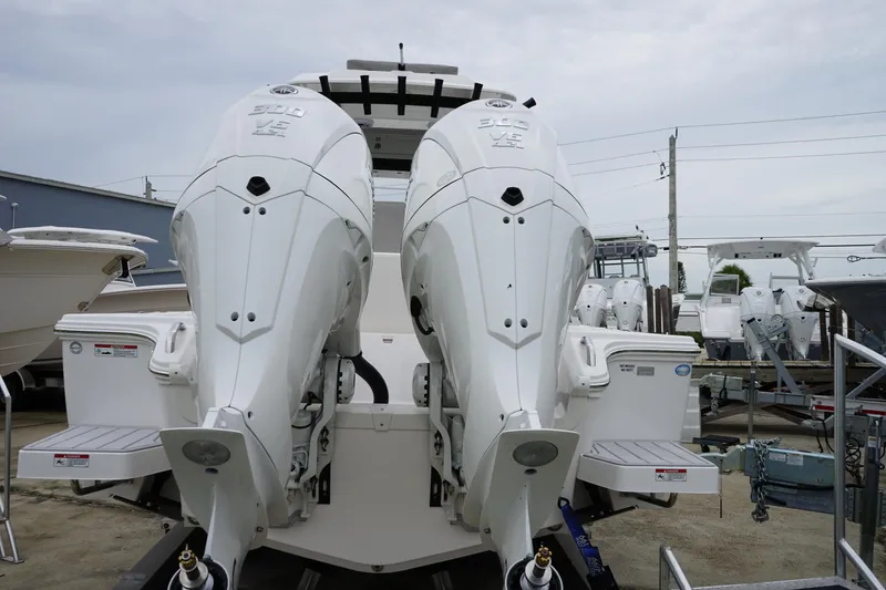 Slide: The Image of 2025 Sea Fox 282 Hybrid LT with dual outboard engines, displayed in a boatyard. - 2