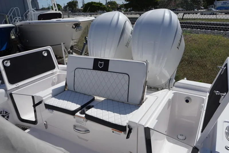 Slide: The Image of 2025 Sea Fox 282 Hybrid LT boat with dual outboard engines and cushioned seating. - 20