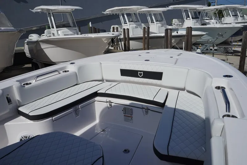 Slide: The Image of 2025 Sea Fox 282 Hybrid LT boat interior with white cushioned seating and sleek design. - 24
