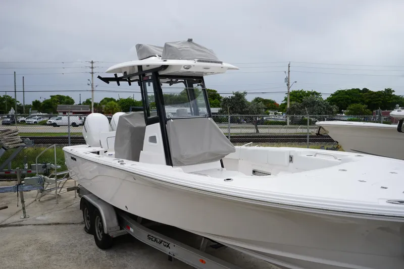 Slide: The Image of 2025 Sea Fox 282 Hybrid LT boat on trailer, parked outdoors. - 6