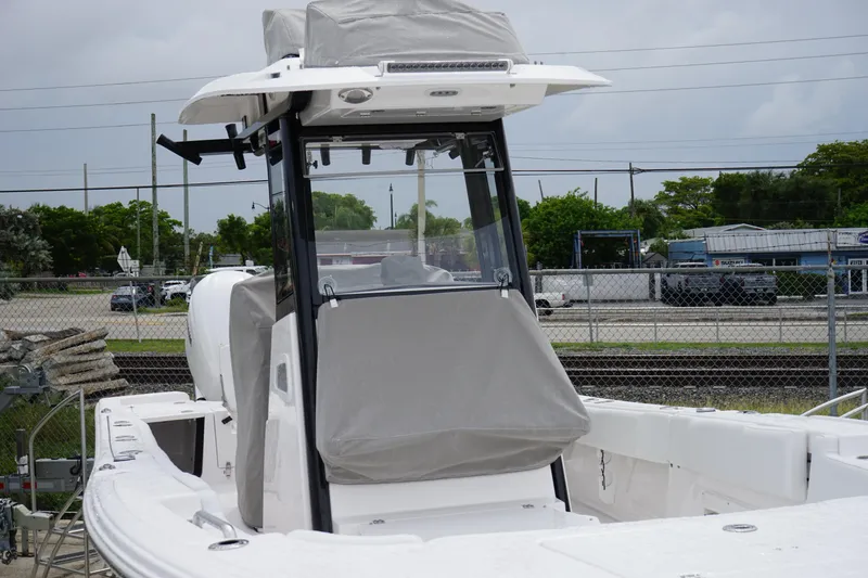 Slide: The Image of 2025 Sea Fox 282 Hybrid LT boat with covered console, parked outdoors. - 8
