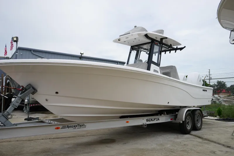 Slide: The Image of 2025 Sea Fox 282 Hybrid LT boat on trailer, parked outdoors. - 9