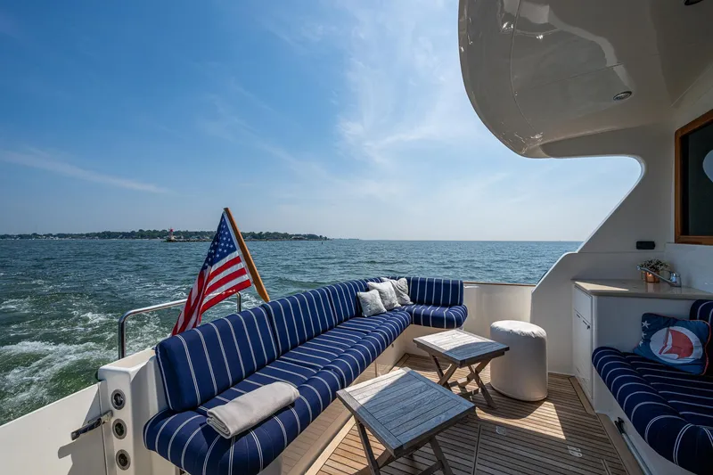 Slide: The Image of Luxurious 2017 Grand Banks 44 Eastbay SX yacht deck with striped seating and ocean view. - 11