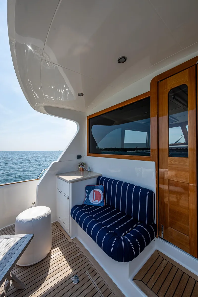 Slide: The Image of 2017 Grand Banks 44 Eastbay SX yacht deck with wooden doors and ocean view. - 16