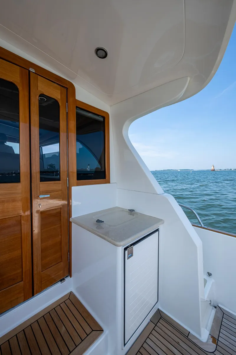 Slide: The Image of 2017 Grand Banks 44 Eastbay SX yacht cruising on open sea under clear blue sky. - 17