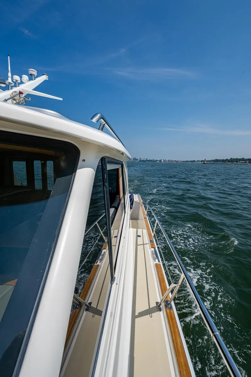Slide: The Image of 2017 Grand Banks 44 Eastbay SX yacht cruising on open water under clear skies. - 19
