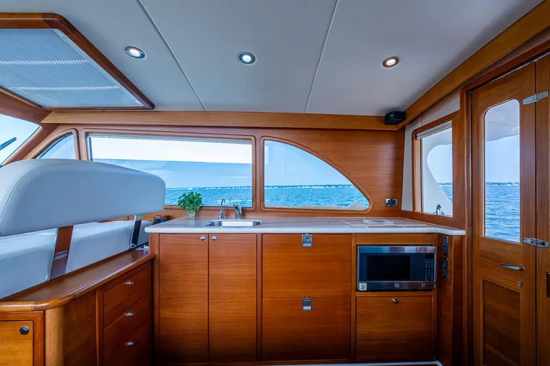 Slide: The Image of Interior helm of 2017 Grand Banks 44 Eastbay SX yacht with ocean view. - 27