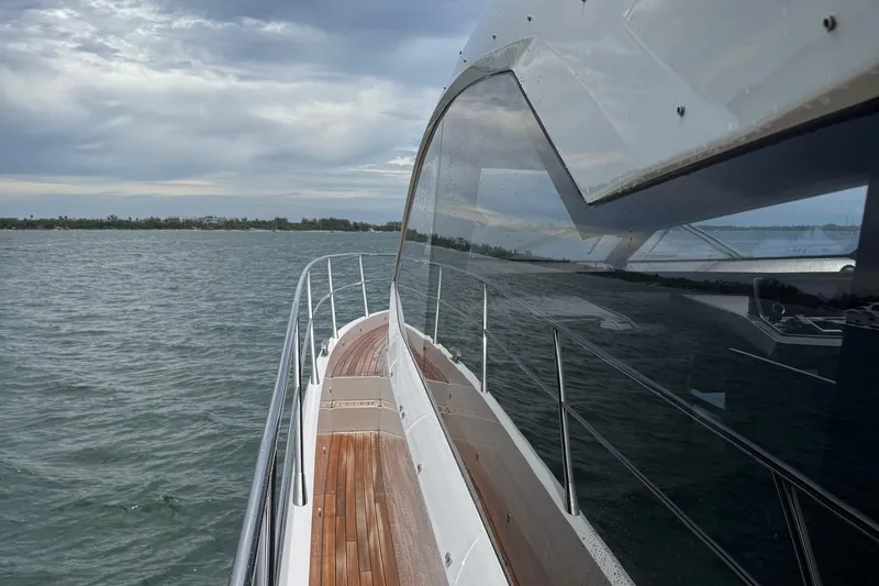 Slide: The Image of 2022 Sunseeker Manhattan 68 yacht cruising on a calm sea under cloudy skies. - 10