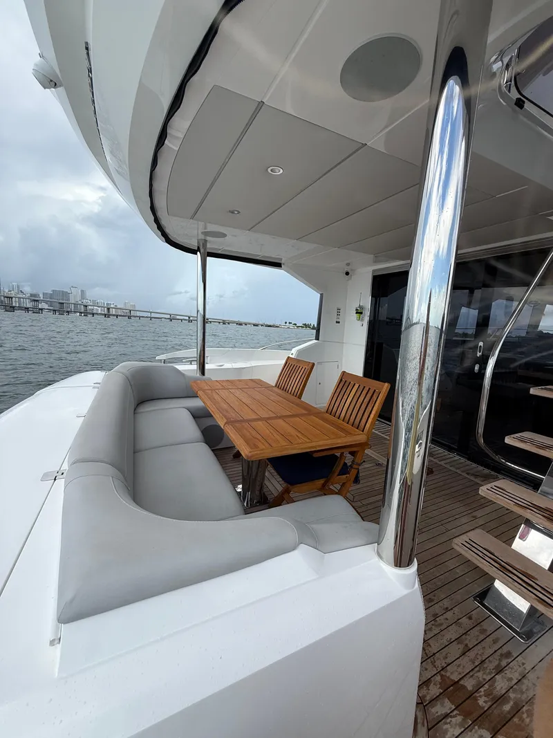 Slide: The Image of Luxurious Sunseeker Manhattan 68 yacht deck with seating and table, 2022 model. - 11