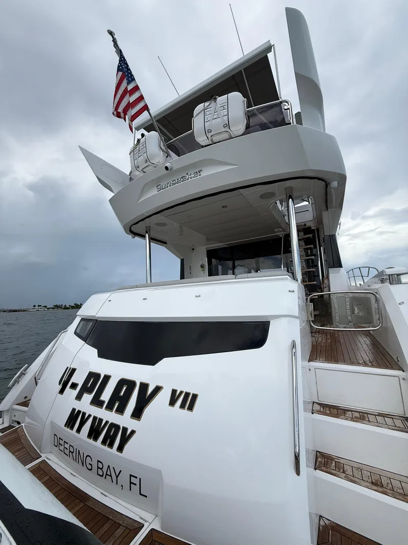 Slide: The Image of 2022 Sunseeker Manhattan 68 yacht with American flag, docked at Deering Bay, FL. - 24