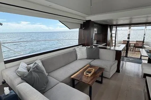 Slide: The Image of Luxurious Sunseeker Manhattan 68 yacht interior with ocean view, featuring elegant seating and modern design. - 32