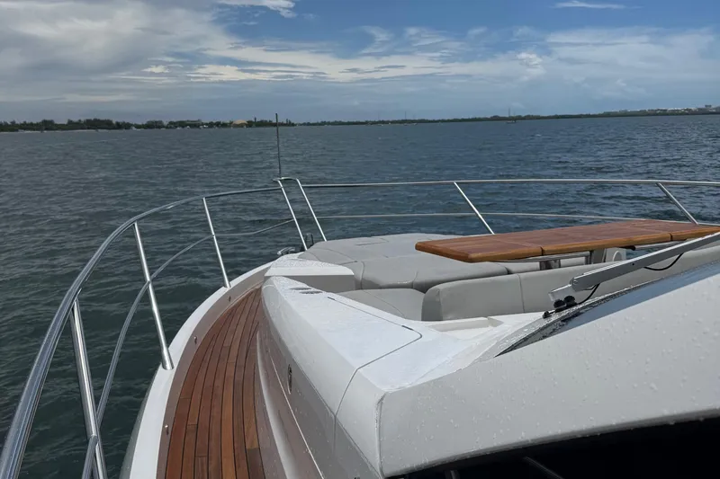 Slide: The Image of Sunseeker Manhattan 68 yacht deck with seating and table, 2022 model, on open water. - 8