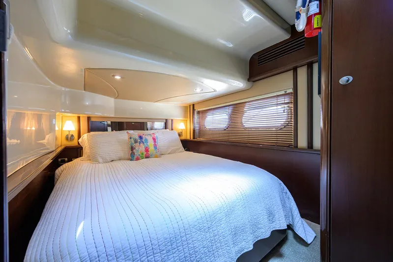 Slide: The Image of Luxurious bedroom interior of 2005 Sea Ray 52 Sedan Bridge yacht with cozy bedding. - 11