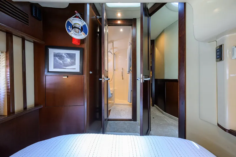 Slide: The Image of Interior of 2005 Sea Ray 52 Sedan Bridge yacht, featuring elegant wood finishes and cozy cabin. - 12