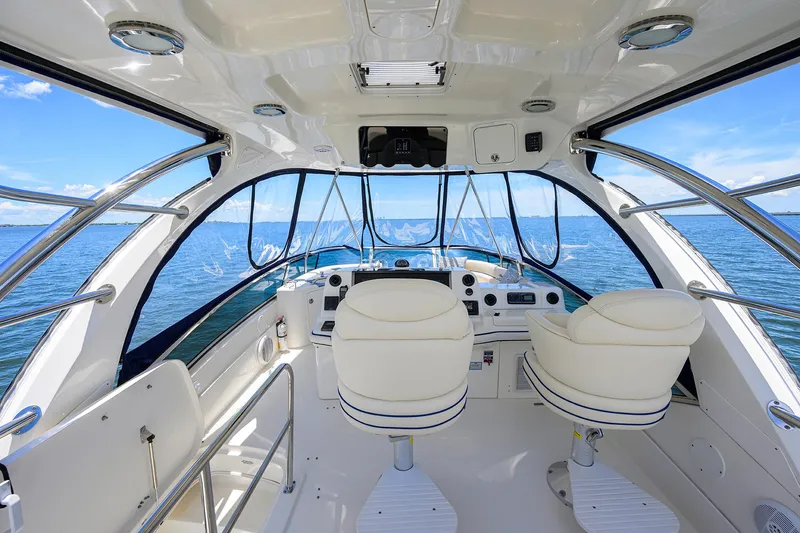 Slide: The Image of Interior view of 2005 Sea Ray 52 Sedan Bridge yacht cockpit with ocean backdrop. - 16