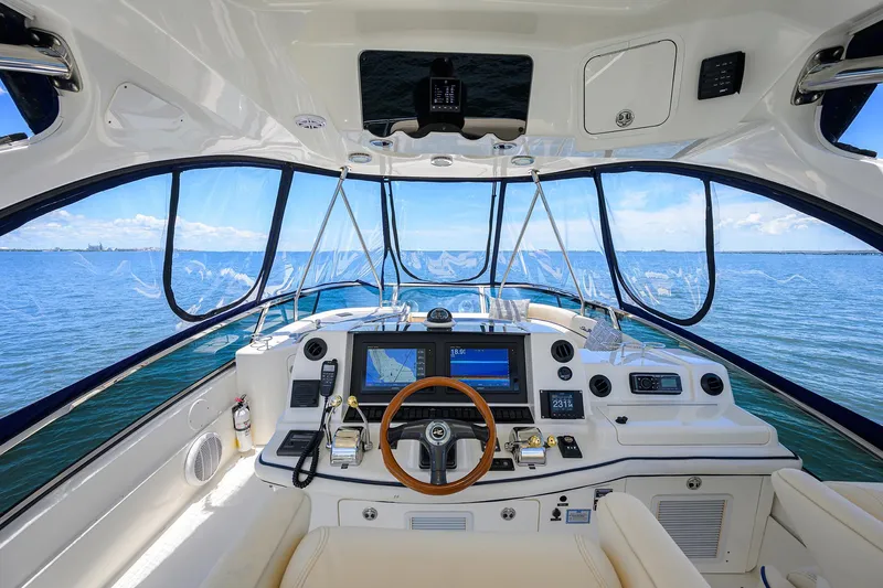 Slide: The Image of 2005 Sea Ray 52 Sedan Bridge helm with panoramic ocean view and advanced navigation system. - 18