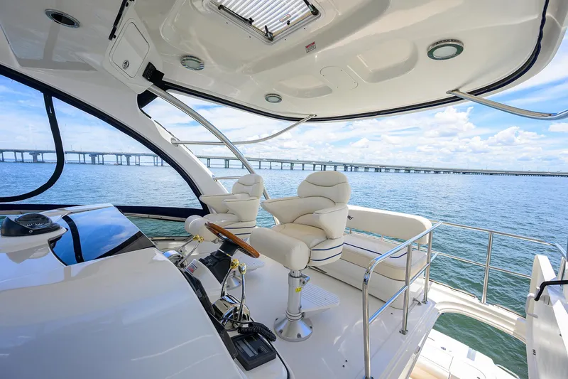 Slide: The Image of 2005 Sea Ray 52 Sedan Bridge helm with ocean view and bridge in background. - 20