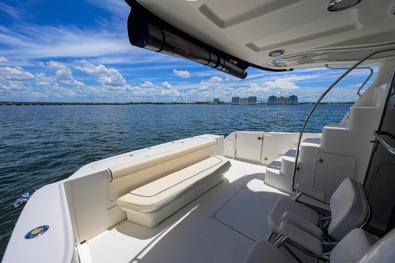 Slide: The Image of 2005 Sea Ray 52 Sedan Bridge yacht deck with ocean view and seating area. - 28
