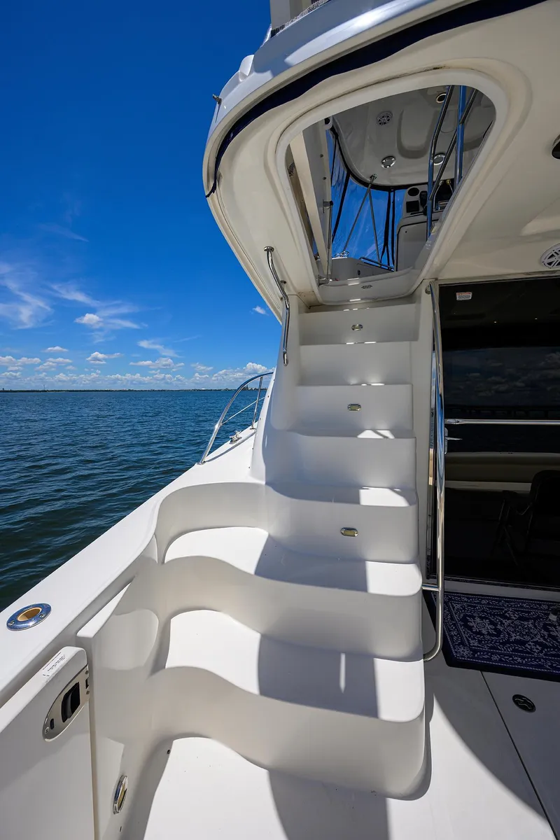 Slide: The Image of 2005 Sea Ray 52 Sedan Bridge yacht with elegant white stairs and ocean view. - 30