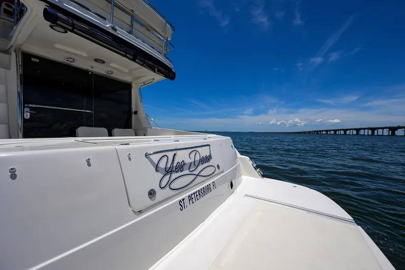 Slide: The Image of 2005 Sea Ray 52 Sedan Bridge yacht on water, clear sky, bridge in background. - 31