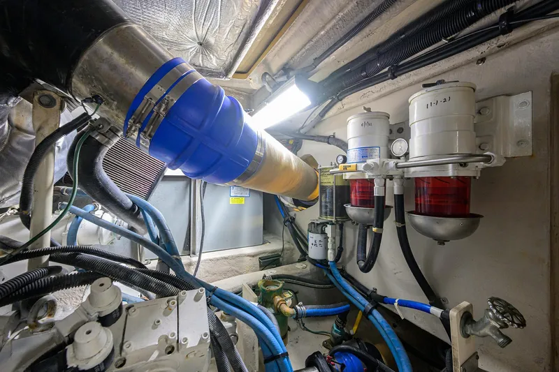 Slide: The Image of Engine room of 2005 Sea Ray 52 Sedan Bridge with visible fuel filters and hoses. - 34